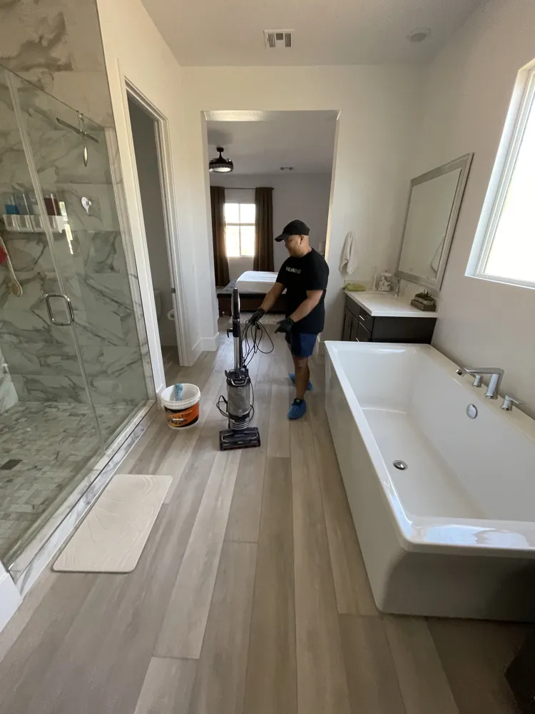 The Clean Guys vacuuming a primary bathroom in a Las Vegas home